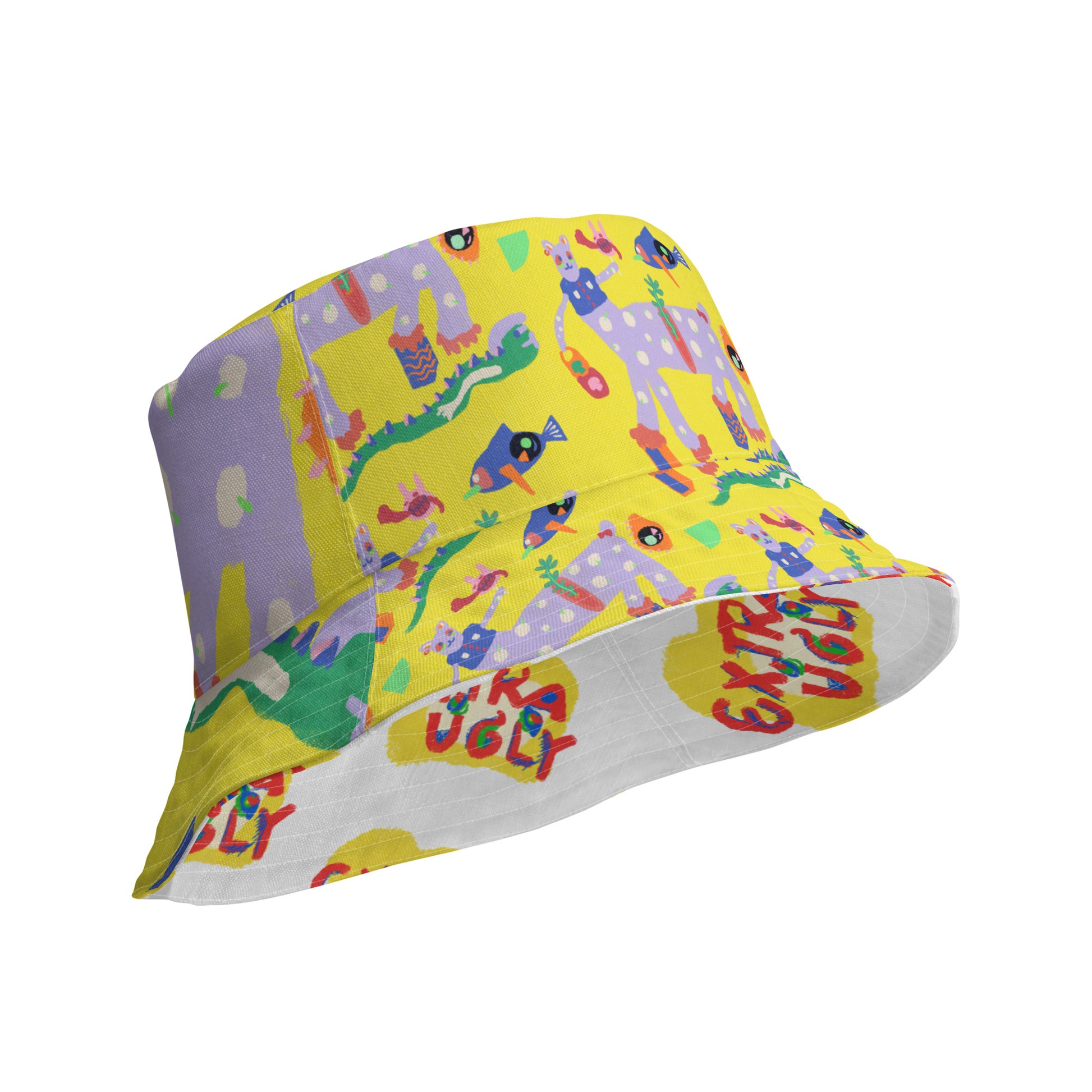 Reversible bucket hat featuring "Yellow Burnout" chaotic animal art on one side and "Extra Ugly" logo on the other, made from breathable fabric.